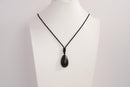 Raw Earth Crystals obsidian teardrop pendant on black cord, crafted from natural obsidian stone, promoting protection, grounding, and emotional clarity.