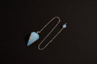 Raw Earth Crystals opal cone pendulum on silver chain, crafted from natural opal stone, enhancing intuition, spiritual insight, and energy balancing.