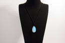 Raw Earth Crystals opal teardrop pendant on black cord, made from natural opal stone, enhancing intuition, emotional healing, and inner clarity.