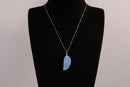 Raw Earth Crystals opalite angel wing pendant, featuring a delicate blue opalite stone carved into an elegant wing shape and set on a silver-tone chain, promoting calmness, spiritual connection, and emotional healing.