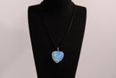 Raw Earth Crystals opalite heart pendant with an elegant rose design, featuring a soft blue opalite stone and a silver-tone vine with leaves, promoting calmness, emotional healing, and spiritual insight.