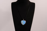 Raw Earth Crystals opalite heart pendant with an elegant rose design, featuring a soft blue opalite stone and a silver-tone vine with leaves, promoting calmness, emotional healing, and spiritual insight.