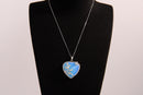 Raw Earth Crystals opalite heart pendant with an elegant rose design, featuring a soft blue opalite stone and a silver-tone vine with leaves, promoting calmness, emotional healing, and spiritual insight.