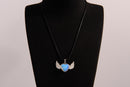 Raw Earth Crystals opalite heart with wings necklace, featuring a luminous blue heart-shaped stone adorned with delicate angelic wings, designed to enhance emotional healing, promote inner peace, and inspire spiritual connection.