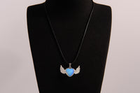 Raw Earth Crystals opalite heart with wings necklace, featuring a luminous blue heart-shaped stone adorned with delicate angelic wings, designed to enhance emotional healing, promote inner peace, and inspire spiritual connection.