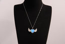 Raw Earth Crystals opalite heart with wings necklace, featuring a luminous blue heart-shaped stone adorned with delicate angelic wings, designed to enhance emotional healing, promote inner peace, and inspire spiritual connection.