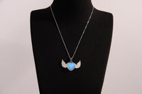 Raw Earth Crystals opalite heart with wings necklace, featuring a luminous blue heart-shaped stone adorned with delicate angelic wings, designed to enhance emotional healing, promote inner peace, and inspire spiritual connection.