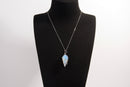 Raw Earth Crystals opalite pendant with a spiral wire wrap design, crafted from natural stone to promote emotional balance, calmness, and inner peace.