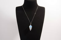 Raw Earth Crystals opalite pendant with a spiral wire wrap design, crafted from natural stone to promote emotional balance, calmness, and inner peace.