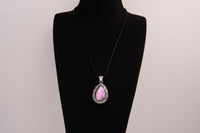 Raw Earth Crystals pink agate pendant with a teardrop-shaped design, featuring natural pink agate and an ornate silver-tone setting, promoting emotional balance, self-love, and gentle energy.