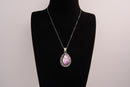 Raw Earth Crystals pink agate pendant with a teardrop-shaped design, featuring natural pink agate and an ornate silver-tone setting, promoting emotional balance, self-love, and gentle energy.