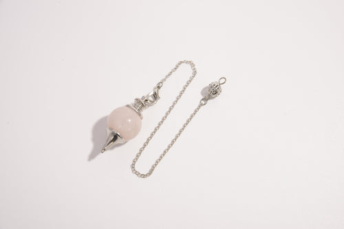Raw Earth Crystals pink quartz pendulum with silver chain, crafted from natural crystal, promotes love, compassion, and emotional healing.
