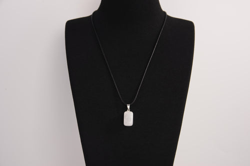 Raw Earth Crystals rectangle pendant featuring a polished opalite cabochon set on a sleek silver-toned bail, displayed on a black leather cord, symbolizing serenity, emotional balance, and spiritual insight.