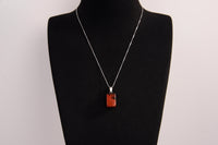 Raw Earth Crystals red jasper rectangle pendant necklace featuring natural crystal jewelry designed for grounding, strength, and emotional stability.