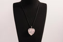 Raw Earth Crystals rose quartz heart pendant with an elegant rose design, featuring a soft pink rose quartz stone and a silver-tone vine with leaves, promoting love, compassion, and emotional healing.