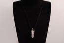 Raw Earth Crystals rose quartz necklace featuring a pointed natural stone pendant, designed to promote love, compassion, and emotional healing.