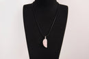 Raw Earth Crystals rose quartz pendant with an angel wing design, crafted from natural stone to encourage love, compassion, and emotional healing.