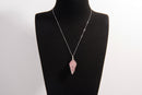 Raw Earth Crystals rose quartz pendant with a spiral wire wrap design, crafted from natural stone to foster love, compassion, and emotional healing.