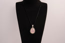 Raw Earth Crystals rose quartz pendant with a teardrop-shaped design, featuring natural rose quartz and an ornate silver-tone setting, promoting love, compassion, and emotional healing.