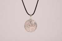 Raw Earth Crystals rose quartz pendant featuring a tree of life design, crafted with natural crystal for love, compassion, and emotional healing.