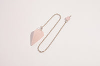 Raw Earth Crystals rose quartz pendulum with pointed crystal and silver chain, crafted for emotional balance, love, and clarity.
