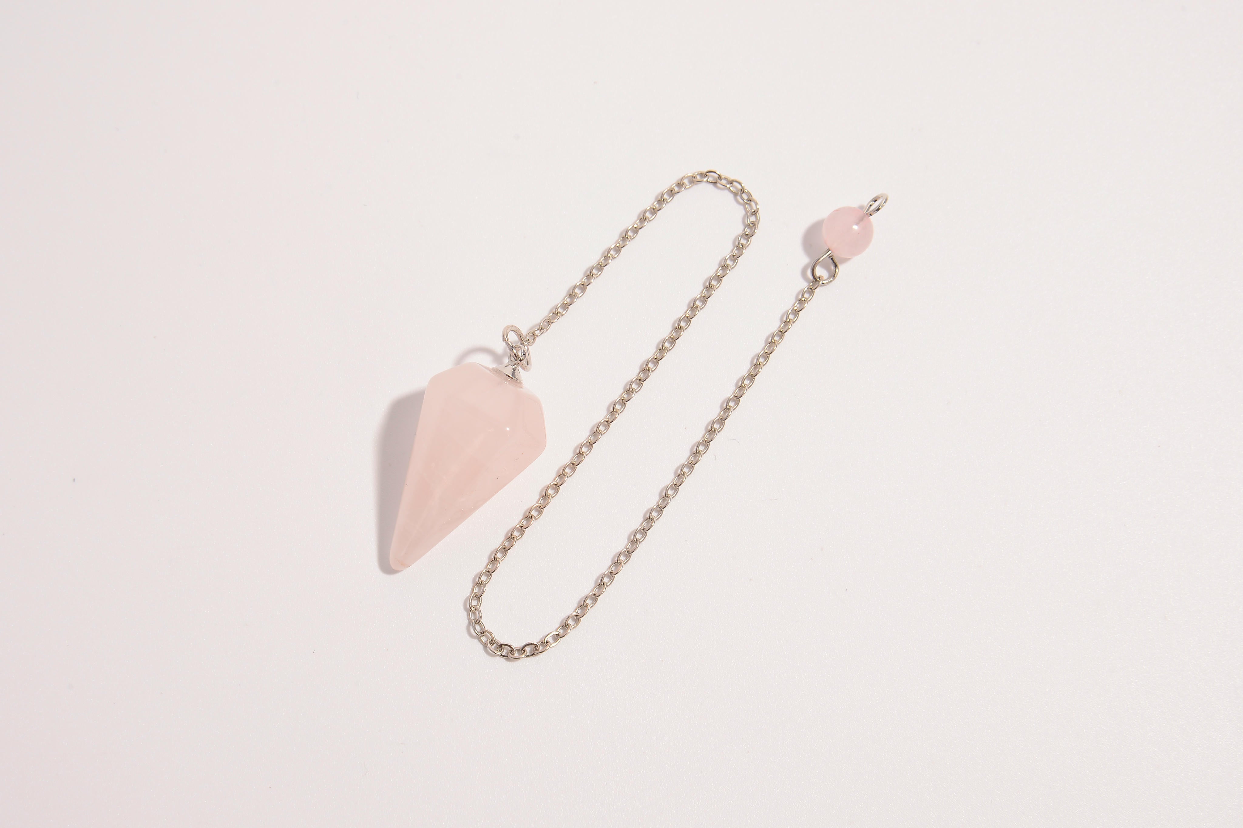 Raw Earth Crystals rose quartz pendulum with pointed crystal and silver chain, crafted for emotional balance, love, and clarity.