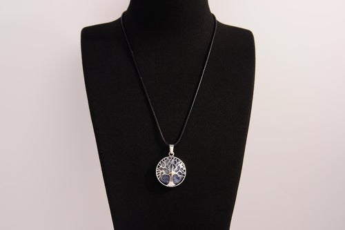 Raw Earth Crystals sodalite pendant featuring a tree of life design, crafted with natural crystal for mental clarity, inner peace, and spiritual connection.