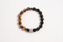 Raw Earth Crystals tiger eye and black onyx faceted bracelet with silver accent, crafted from natural crystals, enhances confidence, protection, and grounding.