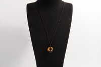 Raw Earth Crystals tiger eye disc pendant necklace made with natural crystal for confidence, focus, and protection.