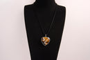 Raw Earth Crystals tiger eye heart pendant with an elegant rose design, featuring a rich golden-brown tiger eye stone and a silver-tone vine with leaves, promoting confidence, clarity, and personal power.