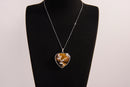 Raw Earth Crystals tiger eye heart pendant with an elegant rose design, featuring a rich golden-brown tiger eye stone and a silver-tone vine with leaves, promoting confidence, clarity, and personal power.