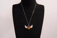 Raw Earth Crystals tiger eye heart with wings necklace, featuring a rich golden-brown heart-shaped stone adorned with delicate angelic wings, designed to enhance confidence, promote clarity, and support personal empowerment.