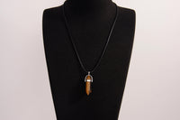 Raw Earth Crystals tiger eye necklace with a pointed natural stone pendant, designed to boost confidence, provide protection, and enhance mental clarity.