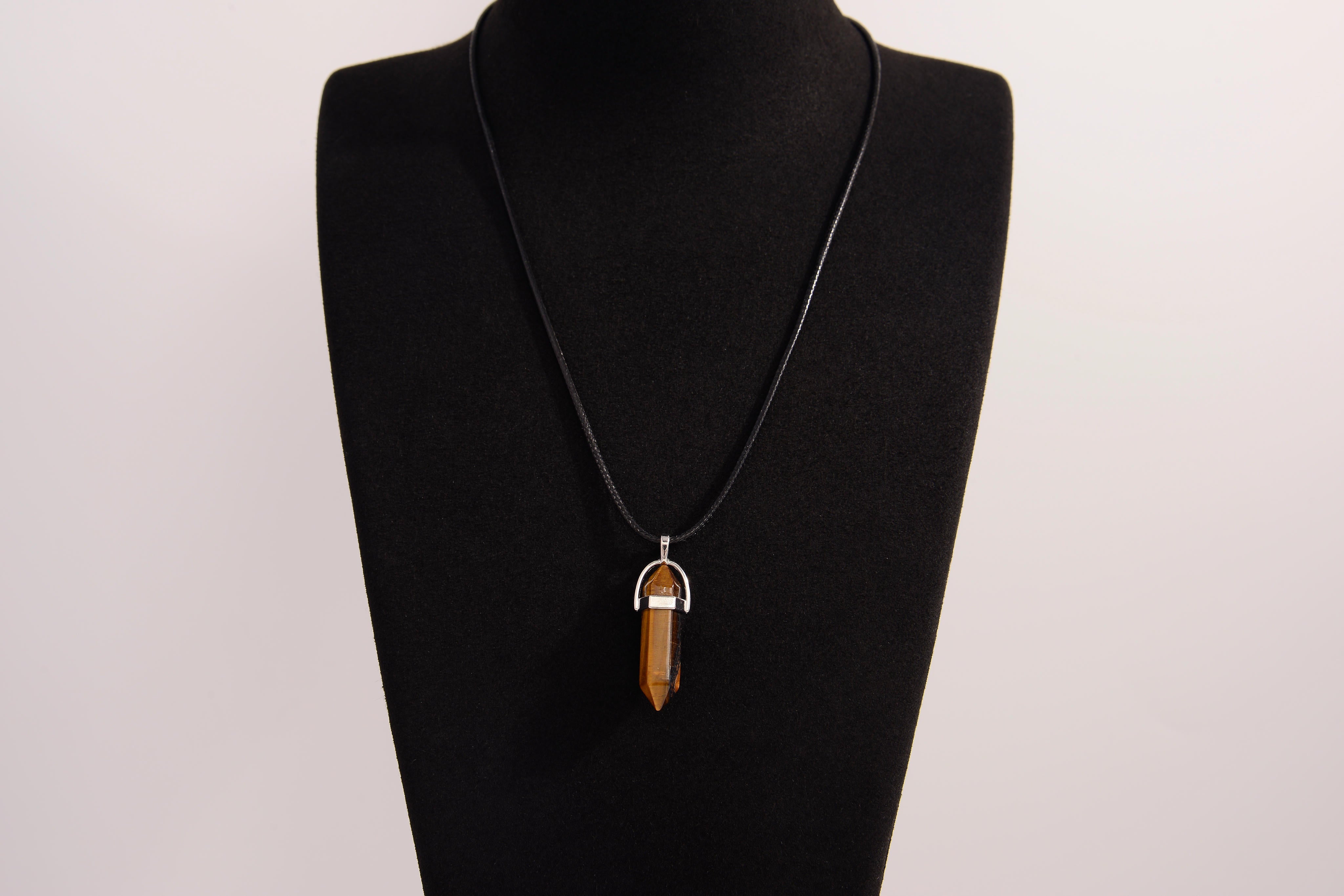 Raw Earth Crystals tiger eye necklace with a pointed natural stone pendant, designed to boost confidence, provide protection, and enhance mental clarity.