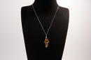 Raw Earth Crystals tiger eye pendant with a spiral wire wrap design, crafted from natural stone to promote confidence, protection, and grounding energy.