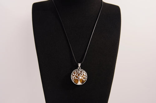 Raw Earth Crystals tiger eye pendant with a tree of life design, made from natural tiger eye and sterling silver, supporting confidence, clarity, and personal power.