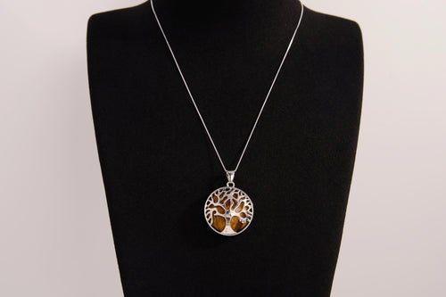 Raw Earth Crystals tiger eye pendant with a tree of life design, made from natural tiger eye and sterling silver, supporting confidence, clarity, and personal power.