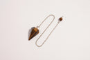 Raw Earth Crystals tiger eye pendulum with pointed crystal and silver chain, crafted for confidence, focus, and grounding energy.