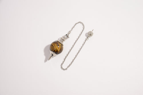 Raw Earth Crystals tiger eye pendulum with silver chain, crafted from natural crystal, promotes confidence, focus, and personal power.