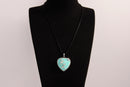 Raw Earth Crystals turquoise heart pendant with an elegant rose design, featuring a vibrant turquoise stone and a silver-tone vine with leaves, promoting communication, creativity, and emotional balance.