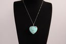 Raw Earth Crystals turquoise heart pendant with an elegant rose design, featuring a vibrant turquoise stone and a silver-tone vine with leaves, promoting communication, creativity, and emotional balance.