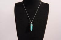 Raw Earth Crystals turquoise necklace featuring a pointed natural stone pendant, designed to promote communication, enhance intuition, and support emotional healing.