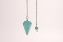 Raw Earth Crystals turquoise pendulum with pointed crystal and silver chain, designed for spiritual protection, communication, and emotional healing.