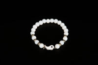 White jade beaded bracelet with yin yang charm from Raw Earth Crystals, featuring natural gemstones for balance, harmony, and spiritual alignment.