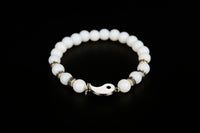 White jade beaded bracelet with yin yang charm from Raw Earth Crystals, featuring natural gemstones for balance, harmony, and spiritual alignment.